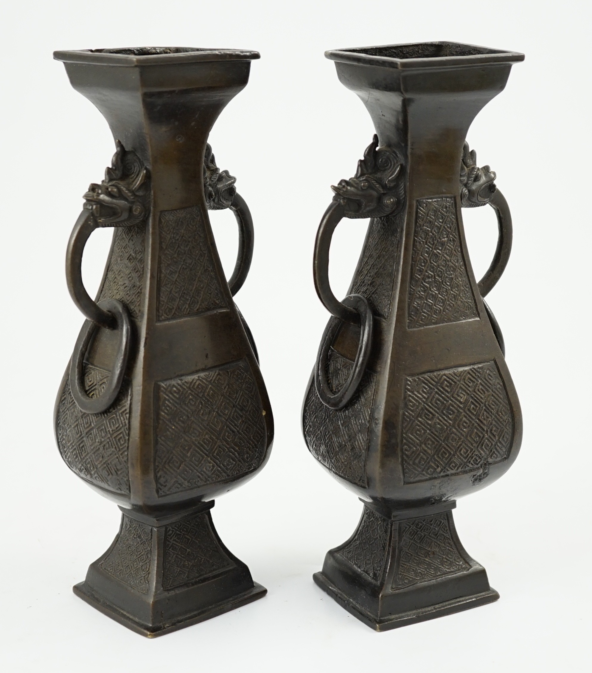 A pair of Chinese archaistic bronze two handled altar vases, Ming dynasty, 23cm high